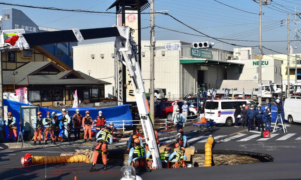 Rescue team saves driver trapped in Japan sinkhole for two days