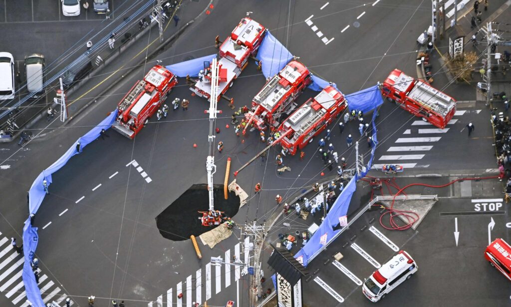 Rescue team saves driver trapped in Japan sinkhole for two days